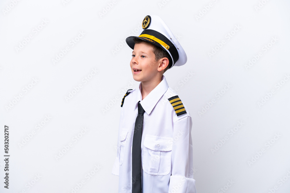 Little airplane pilot boy isolated on white background laughing in lateral position Little airplane pilot boy isolated on white background laughing in lateral position