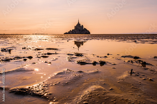 Sunset and reflection on the bay of Mont Saint Michel, Normandy, France