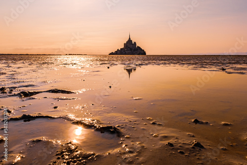 Sunset and reflection on the bay of Mont Saint Michel