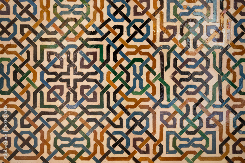 Ornamental medieval ceramic tiles of walls in Nasrid Palaces in the Alhambra palace Granada, Andalusia, Spain Ornamental medieval ceramic tiles of walls in Nasrid Palaces in the Alhambra palace Granada, Andalusia, Spain