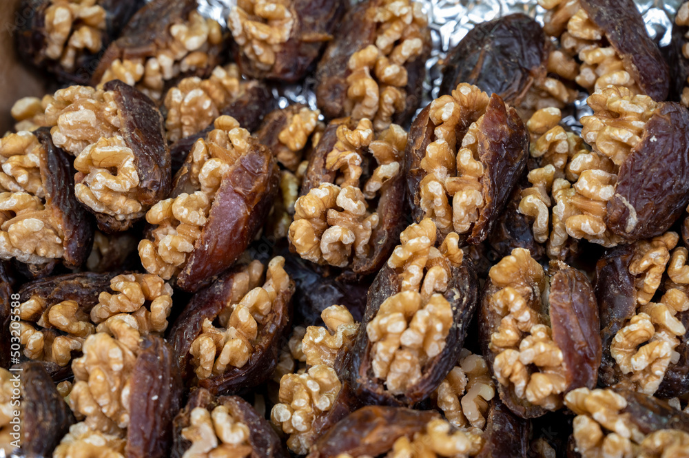Turkish or arabic sweet dessert, ripe dried dadels with walnuts sweetened with syrup or honey. Turkish or arabic sweet dessert, ripe dried dadels with walnuts sweetened with syrup or honey.
