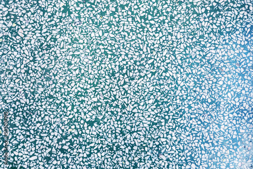Fragment of a ceramic floor with green stones. texture background. texture with colorful spots, for add text or work design for backdrop product. top view