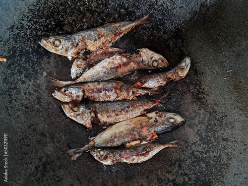 Sea fish fried in a pan with six spices