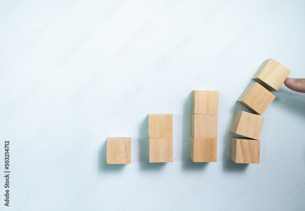 Top view finger push wooden blocks from collapse. Concept for protecting business.