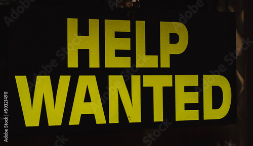A help wanted sign displayed in the window of a local A&W restaurant