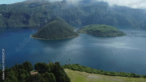 Laguna Cuicocha, Ecuador: Aerial drone footage with tilt up motion of the Laguna Cuicocha at the foot of the Cotacachi volcano near Otavalo in the Andes mountains in Ecuador in south America  photo