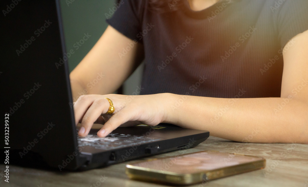 Fototapeta premium Female businessman hands using computer on desk, work outside the office and home concept