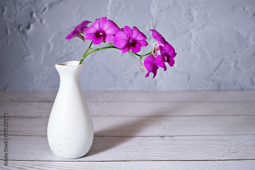 Purple flowers in vase on the table,Purple-pink flower orchids still life background or wallapper cooktown ,Dendrobium bigibbum mauve butterfly orchid ,Callista bigibba Callista sumneri blooming 