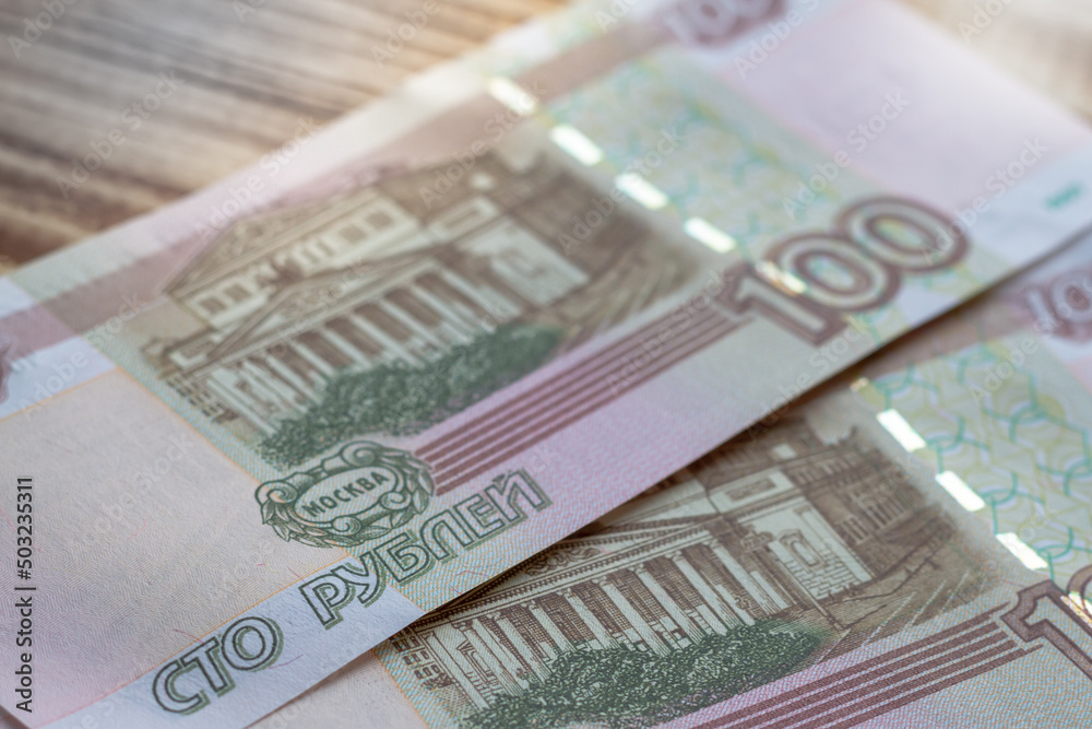 Russian banknotes of one hundred rubles are on the table