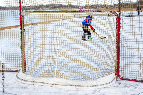 Photography Boy playing icehockey on Finjasjon lake in Hassleholm, Sweden