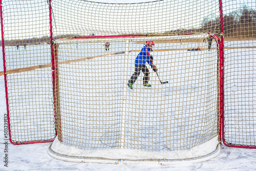Photography Boy playing icehockey on Finjasjon lake in Hassleholm, Sweden