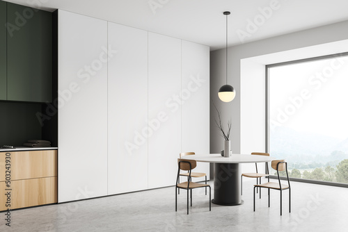 Light dining room interior with chairs and table, panoramic window photo