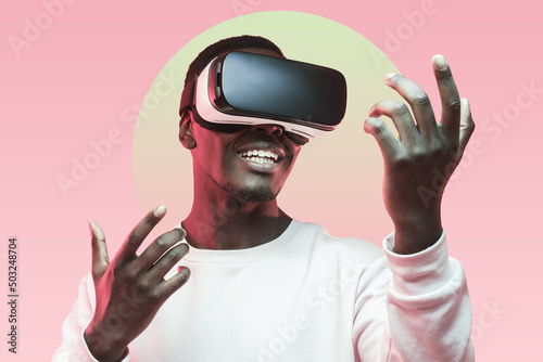 Smiling african man using virtual reality headset for playing games