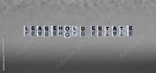 leasehold estate word or concept represented by black and white letter cubes on a grey horizon background stretching to infinity