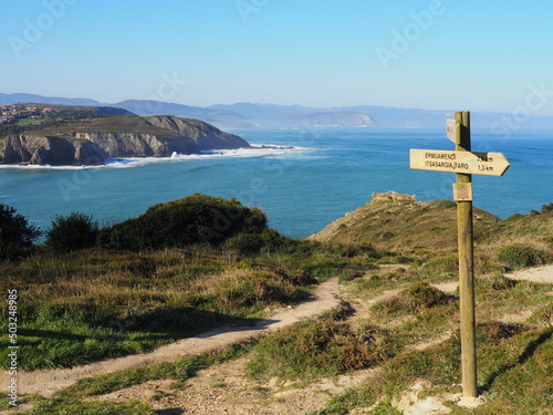 Ruta al faro de Gorliz, desde la playa y entre preciosos acantilados. España. photo