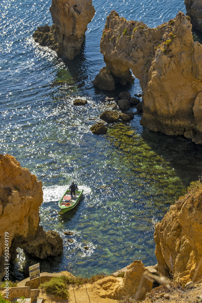 Panoramic view with Cliff, rocks and tourist boat on sea at Ponta da Piedade near Lagos, Algarve, Portugal Panoramic view with Cliff, rocks and tourist boat on sea at Ponta da Piedade near Lagos, Algarve, Portugal