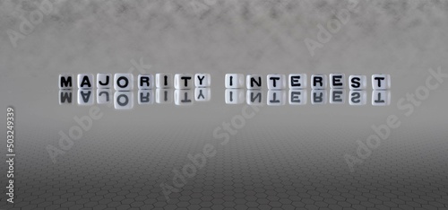 majority interest word or concept represented by black and white letter cubes on a grey horizon background stretching to infinity