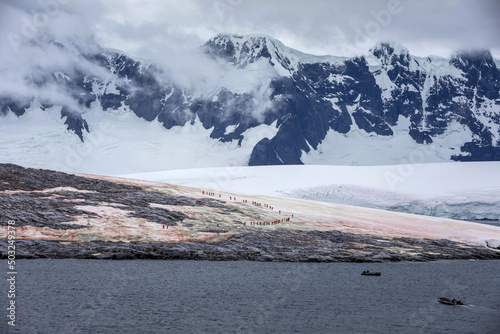 Landing on the coast of sakotan, the snow capped mountains of the Antarctic continent photo