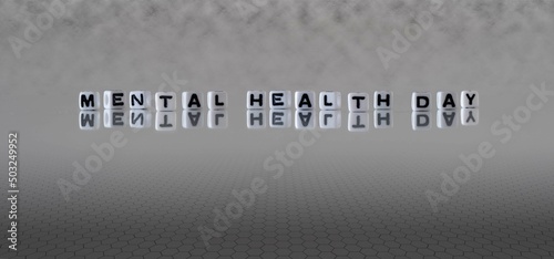 mental health day word or concept represented by black and white letter cubes on a grey horizon background stretching to infinity