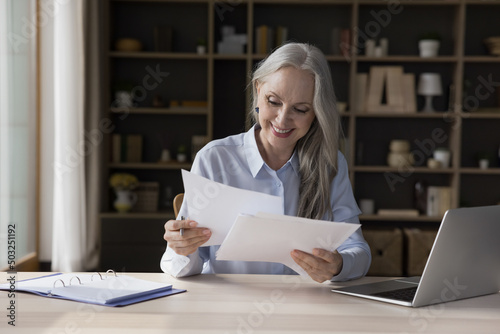 фотографія Happy positive senior professional woman reviewing insurance, loan, mortgage, re
