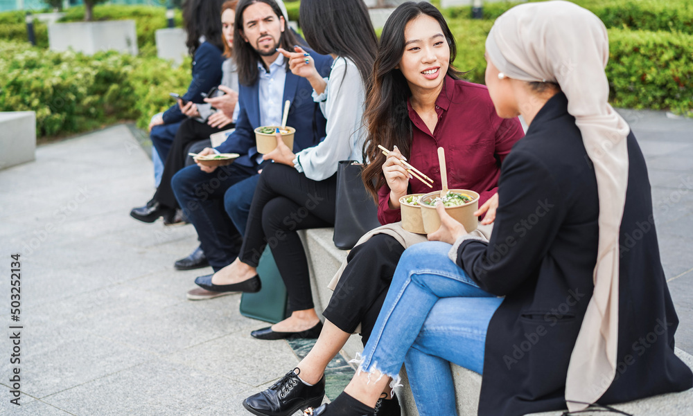 Fototapeta premium Multiethnic business people doing lunch break outdoor from office building - Meeting and entrepreneur concept