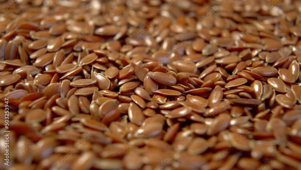 Flax seeds heap close up. Brown linseeds. Macro. Rotation Flax seeds heap close up. Brown linseeds. Macro. Rotation
