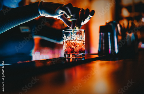 Canvas Print woman bartender hand making cocktail in nightclub