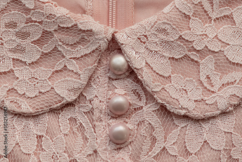 fine art detail of soft pink white lace fabric collar of classic dress of girl photo