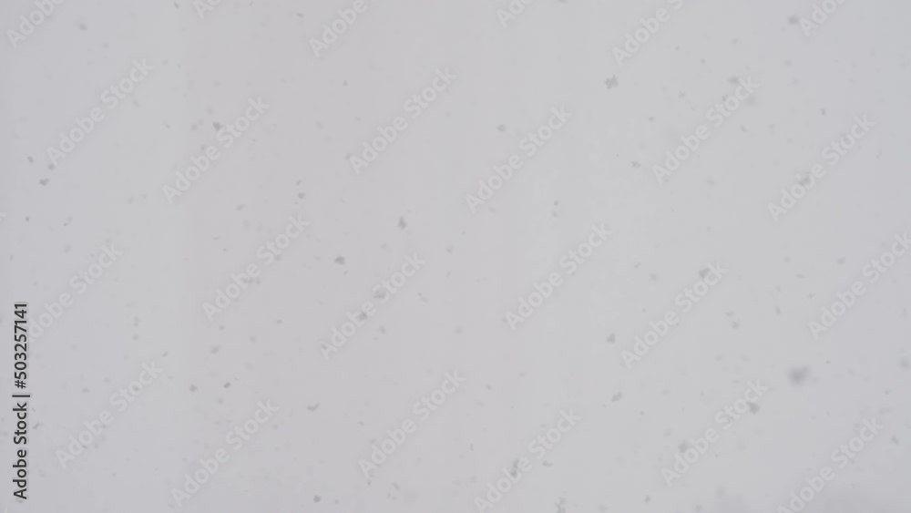 Slow motion snow falling over white clouds Slow motion snow falling over white clouds
