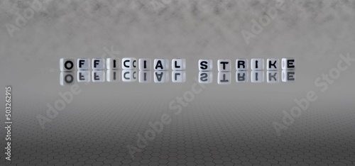 official strike word or concept represented by black and white letter cubes on a grey horizon background stretching to infinity