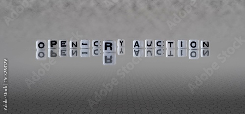 open cry auction word or concept represented by black and white letter cubes on a grey horizon background stretching to infinity