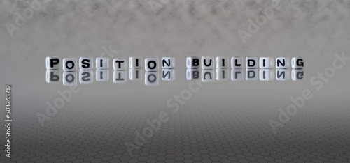 position building word or concept represented by black and white letter cubes on a grey horizon background stretching to infinity