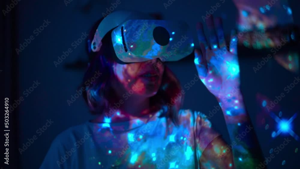 Woman is using virtual reality headset. Elements of this image furnished by NASA. Video slow mo, slow motion. Woman is using virtual reality headset. Elements of this image furnished by NASA. Video slow mo, slow motion.