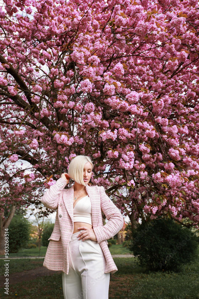 Outdoors portrait of Beautiful woman in pink blossoms on spring day Outdoors portrait of Beautiful woman in pink blossoms on spring day