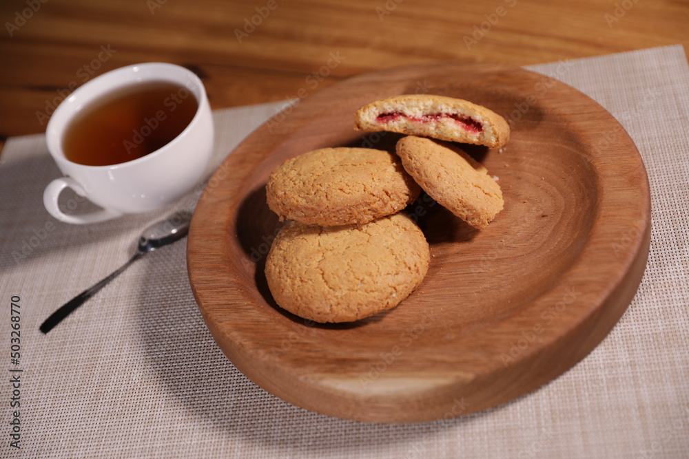 berry tea and a decorative wooden plate is very beautiful for vegetables and cookies, sweets and desserts as an element of decor for interior design berry tea and a decorative wooden plate is very beautiful for vegetables and cookies, sweets and desserts as an element of decor for interior design