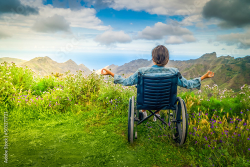 Canvas Disabled handicapped woman in wheelchair on mountain hill enjoying view