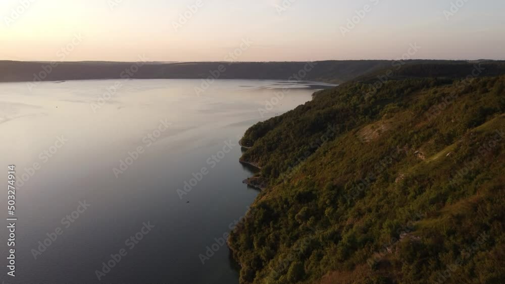 Aerial view of wide Dnister river and distant rocky hills in Bakota area, part of the National park, Podilski Tovtry, in Ukraine. 4k. High quality 4k footage. Aerial view of wide Dnister river and distant rocky hills in Bakota area, part of the National park, Podilski Tovtry, in Ukraine. 4k. High quality 4k footage.