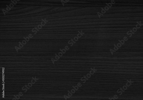 wood texture. surface of teak wood background in dark black color for design and decoration. wooden laminated for interior furnishing work. artificial wood use as background with space for design.