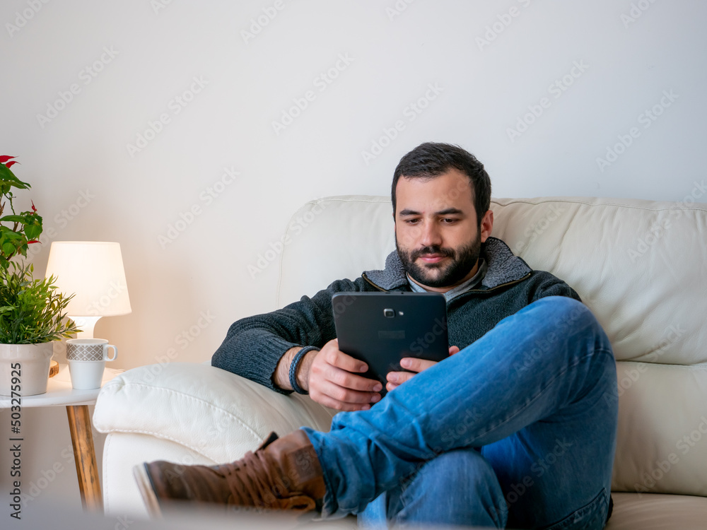 Fototapeta premium student working and relaxing in home with tablet
