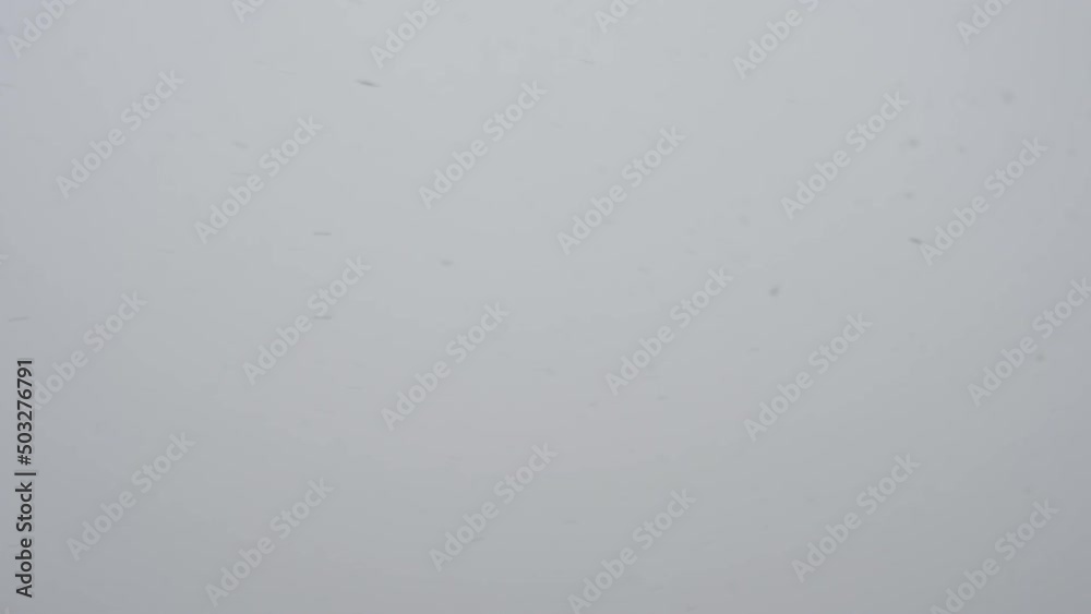 Slow motion snow falling over white clouds Slow motion snow falling over white clouds