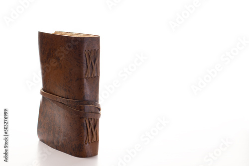 antique notebook or diary with leather cover and antique papyrus-type pages with white background and space for text 