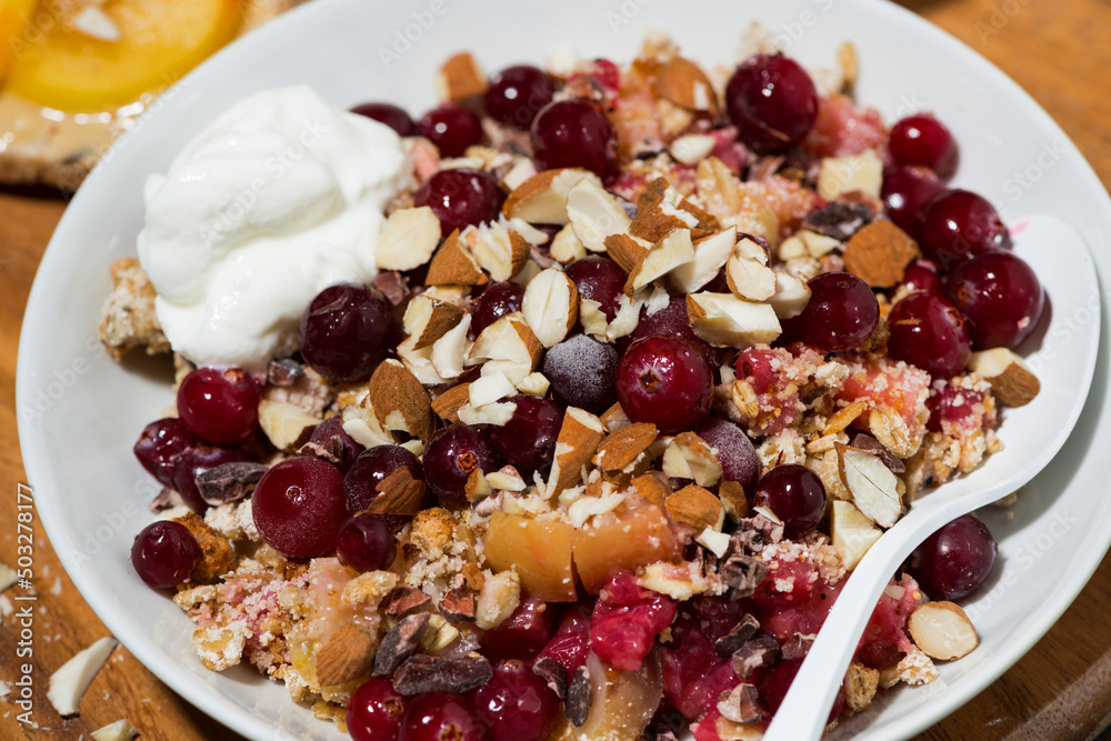 sweet crumble with fresh berries for breakfast, closeup sweet crumble with fresh berries for breakfast, closeup