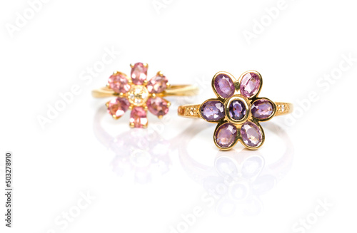 Purple Sapphire Jewel or gems ring on white background with reflection. Pink Tourmaline ring was placed next to it. Collection of natural gemstones accessories. Studio shot