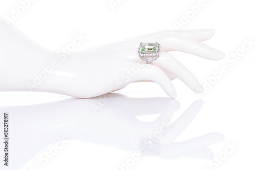Aquamarine with diamonds ring on plastic mannequin female hand. Collection of natural gemstones accessories. Studio shot
