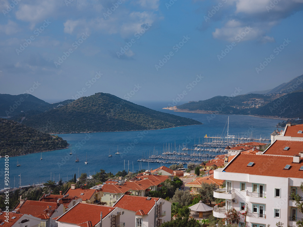 Harbour of city Kas or Kash in Turkey and Greek island Kastelorizo. Charming view of seaside resort town. Romantic harbour with yacht marina and mosque with minarets