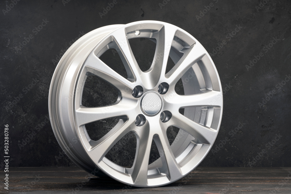 silver new alloy wheel . close-up of auto parts