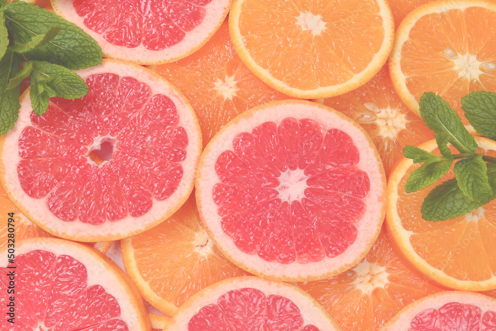 Slices of oranges and a grapefruits and mint as a background. Slices of oranges and a grapefruits and mint as a background.