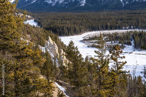 Hoodoos Viewpoint, Banff National Park beautiful landscape. Panorama view Mount Rundle valley forest and frozen Bow River in winter. Canadian Rockies.