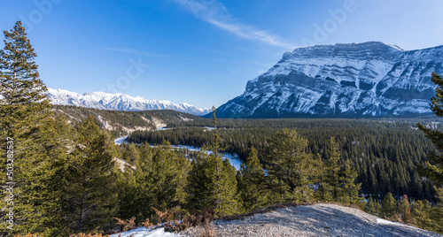 Banff National Park, Canadian Rockies beautiful scenery. Snowcapped Mount Rundle, fir trees forest in snowy winter day.