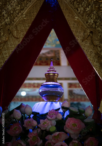 Glass jar of Buddha's relics at Wat Nong Waeng. A temple in  Khon Kaen provience, Thailand. spot focus photo